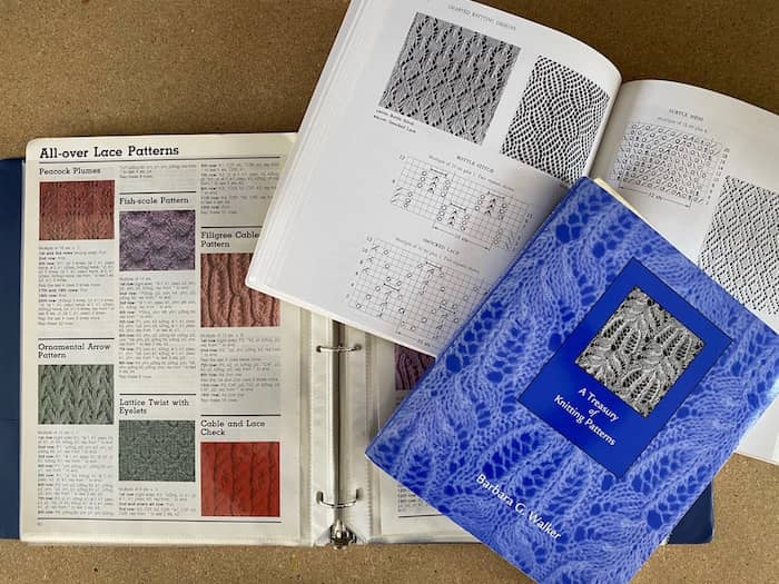 knitting pattern books and 3-ring binder of pages from knitting book that fell a art