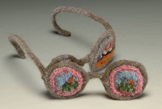 Through Rose Colored Glasses, knitted sculpture, two sets of lenses on eyeglasses, 3 x 6 x 10 in © 2004 Eve Jacobs-Carnahan.