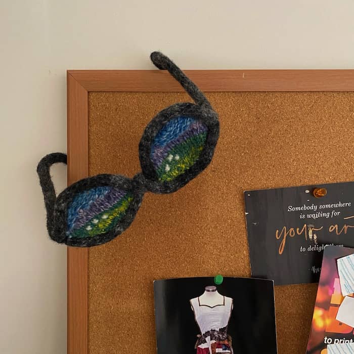 Mountain View, fiberart sculpture in eyeglasses series, wool, wire, hanging from studio bulletin board, ©2002 Eve Jacobs-Carnahan 