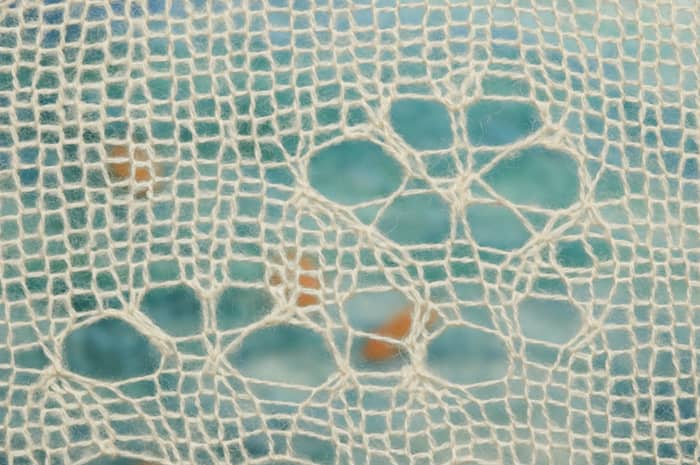 lace knitting layered over felted blue - artwork detail by Eve Jacobs-Carnahan
