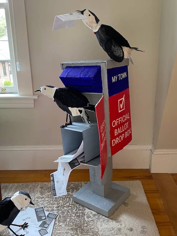 allegorical sculpture by Eve Jacobs-Carnahan with owl and pigeons referencing election campaign donations